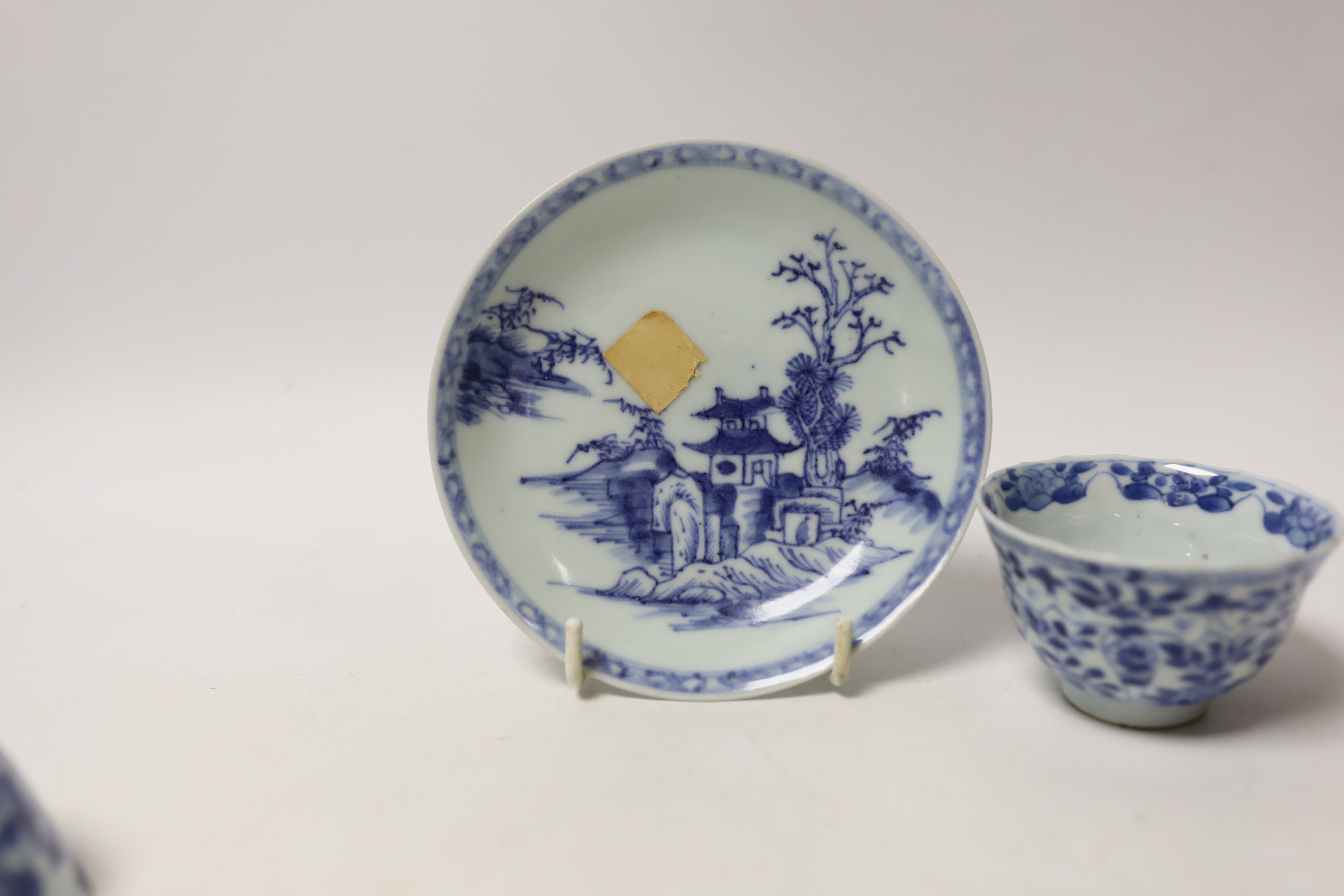A Chinese Nanking Cargo blue and white saucer and tea bowl, and a Kangxi blue and white tea bowl, largest 11.5cm in diameter